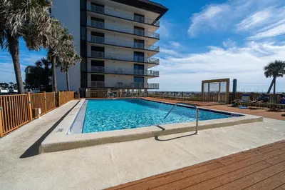 a swimming pool in front of a building at Edgewater Oasis Gorgeous Resort Condo on Beach in Panama City Beach