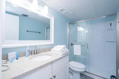 a bathroom with a toilet and a sink and a shower at Edgewater Oasis Gorgeous Resort Condo on Beach in Panama City Beach