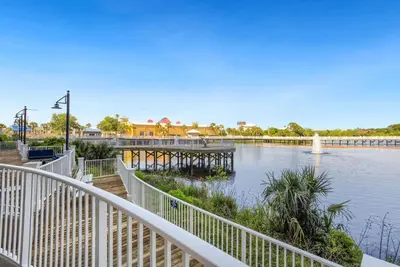 a bridge over a river with a dock in the water at Seaside Harmony - Stunning High-Rise Resort Condo in Panama City Beach