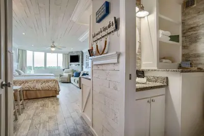 a kitchen and a living room with a bed in a room at Seaside Villa - Ocean View Studio in Panama City Beach