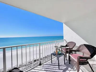 a balcony with chairs and a view of the beach at Once Upon A Dream - Beachfront Bliss in Panama City Beach