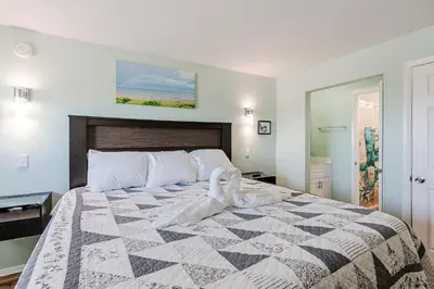 a bedroom with a bed with a quilt on it at Once Upon A Dream - Beachfront Bliss in Panama City Beach