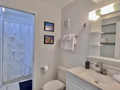 a bathroom with a toilet and a sink and a shower at Once Upon A Dream - Beachfront Bliss in Panama City Beach