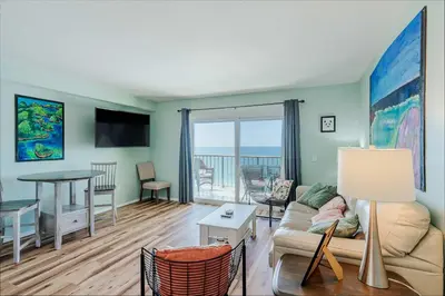 a living room with a couch and a table at Once Upon A Dream - Beachfront Bliss in Panama City Beach