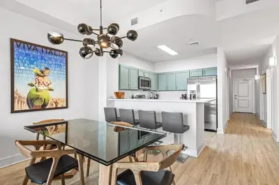 a dining room and kitchen with a glass table and chairs at Salt and Shore Escape - Sleeps 7 in Panama City Beach
