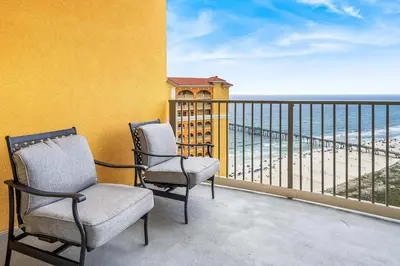 two chairs on a balcony with a view of the beach at Salt and Shore Escape - Sleeps 7 in Panama City Beach