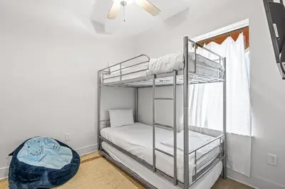 a bedroom with two bunk beds and a window at Salt and Shore Escape - Sleeps 7 in Panama City Beach
