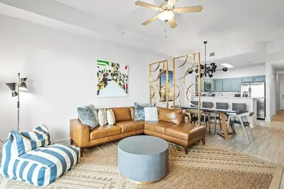 a living room with a couch and a table at Salt and Shore Escape - Sleeps 7 in Panama City Beach