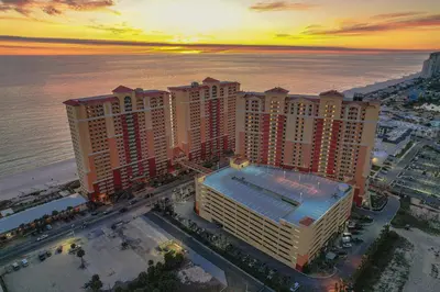 an aerial view of a resort near the ocean at sunset at Sandy Feet Retreat - Ocean View Condo in Panama City Beach