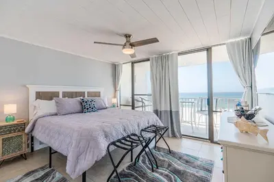 a bedroom with a bed with a view of the ocean at Beachfront Days Ocean View Condo Bliss in Panama City Beach