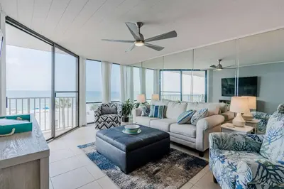 a living room with a couch and a ceiling fan at Beachfront Days Ocean View Condo Bliss in Panama City Beach
