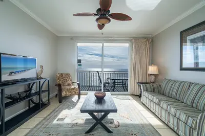 a living room with a couch and a flat screen tv at Beachfront Haven 2 BDR Kid-Friendly Resort in Panama City Beach