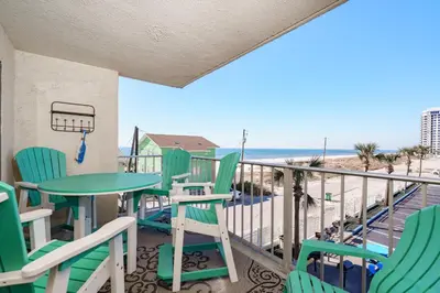a balcony with a table and chairs and the beach at Bethys Beachy Beauty Regency Towers in Panama City Beach