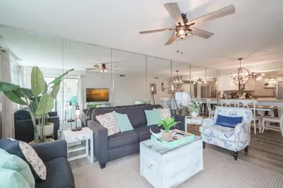 a living room with a couch and a table at Bethys Beachy Beauty Regency Towers in Panama City Beach