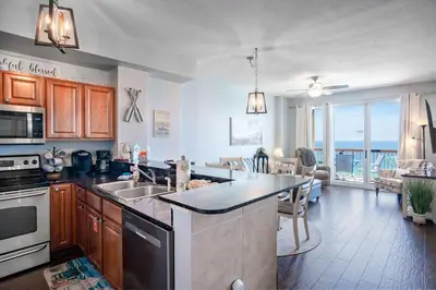 a kitchen with a sink and a counter top at Sunrise Sands - An Unforgettable Vacation for 7 in Panama City Beach