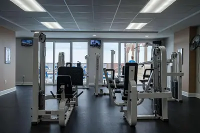 a gym with cardio equipment in a building at Sunrise Sands - An Unforgettable Vacation for 7 in Panama City Beach