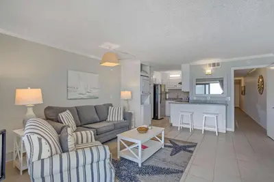 a living room with a couch and a table at Sunrise Sunset - Full Ocean Views in Panama City Beach