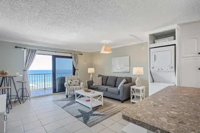 a living room with a couch and a table at Sunrise Sunset - Full Ocean Views in Panama City Beach