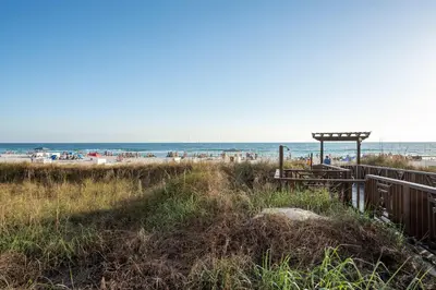a beach with the ocean in the background at Sunset Shores - Oceanfront Condo Bliss in Panama City Beach