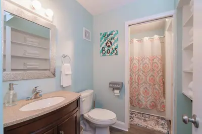 a bathroom with a toilet and a sink and a shower at Turtle Love - Resort Amenities & Ocean Views in Panama City Beach