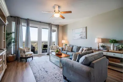 a living room with a couch and a ceiling fan at Whitesands Retreat - Incredible Resort Home in Panama City Beach