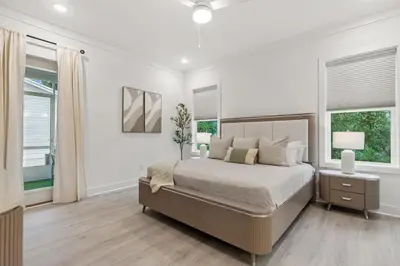 a white bedroom with a bed and two windows at 224 W Willow Mist Rd in Inlet Beach
