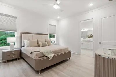 a bedroom with a bed and a bathroom with windows at 224 W Willow Mist Rd in Inlet Beach