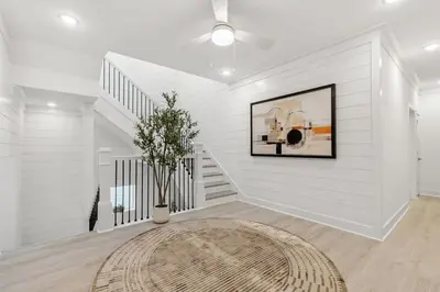 a white room with a staircase and a rug at 224 W Willow Mist Rd in Inlet Beach