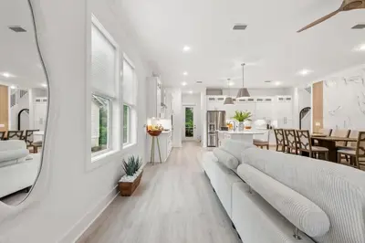 a living room with a white couch and a kitchen at 224 W Willow Mist Rd in Inlet Beach