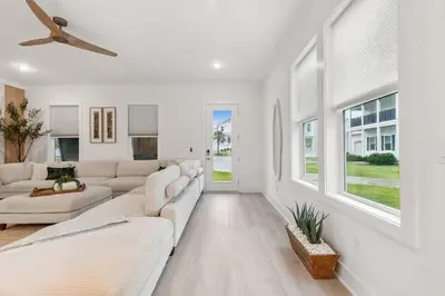 a living room with white furniture and a ceiling fan at 224 W Willow Mist Rd in Inlet Beach