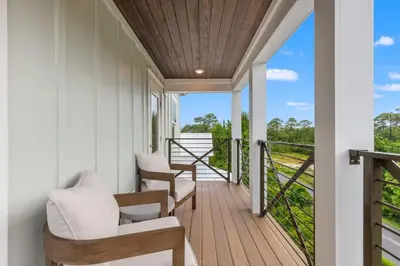 a porch with chairs and a balcony with a view at 224 W Willow Mist Rd in Inlet Beach