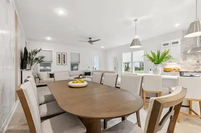 a kitchen and dining room with a wooden table and chairs at 224 W Willow Mist Rd in Inlet Beach