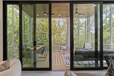 a living room with glass doors and a patio at New 30A Retreat Beach Access Hot Tub & Guest Suite in Seacrest