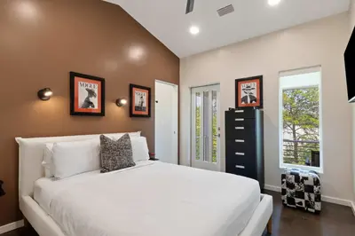 a bedroom with a white bed and two windows at New 30A Retreat Beach Access Hot Tub & Guest Suite in Seacrest