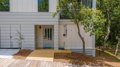a house with a wooden porch with a blue door at New 30A Retreat Beach Access Hot Tub & Guest Suite in Seacrest