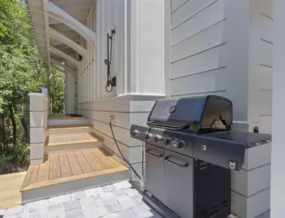 a grill on the side of a house with a porch at New 30A Retreat Beach Access Hot Tub & Guest Suite in Seacrest