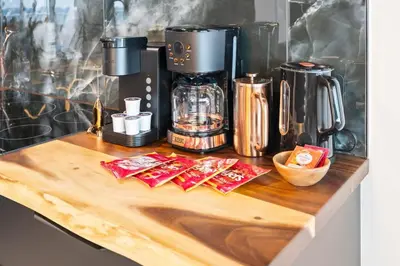 a counter with a coffee maker on a wooden table at The Summit Penthouse 1501 in Panama City Beach