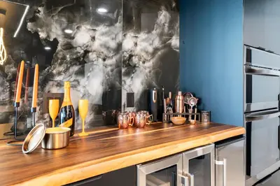 a kitchen with a wooden counter top with bottles of wine at The Summit Penthouse 1501 in Panama City Beach