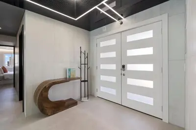 a bathroom with a wooden pivot door in a room at The Summit Penthouse 1501 in Panama City Beach