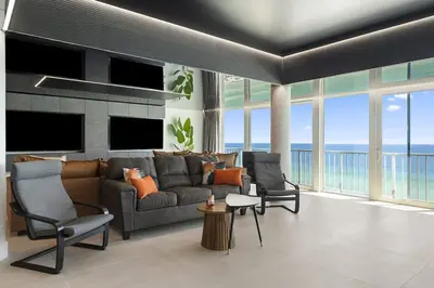 a living room with a couch and two chairs at The Summit Penthouse 1501 in Panama City Beach