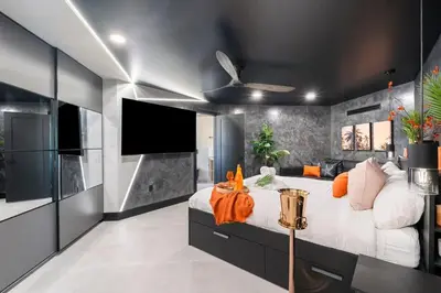 a bedroom with a large bed and a flat screen tv at The Summit Penthouse 1501 in Panama City Beach