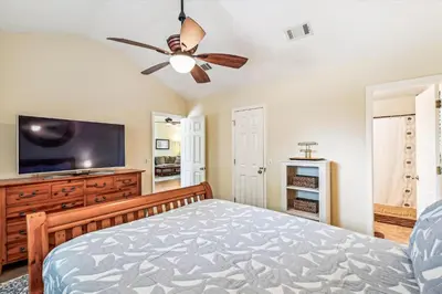 a bedroom with a bed and a flat screen tv at 17007 Firenzo Ave home in Panama City Beach