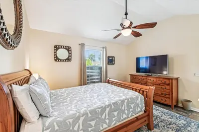 a bedroom with a bed and a flat screen tv at 17007 Firenzo Ave home in Panama City Beach