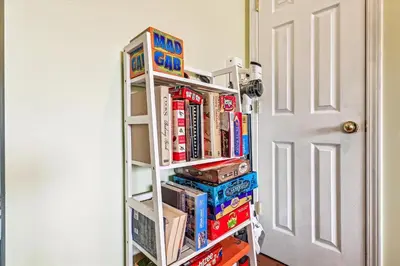 a book shelf filled with books next to a door at 17007 Firenzo Ave home in Panama City Beach