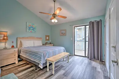 a bedroom with a bed and a ceiling fan at Steps to the Beach PCB Condo with Balcony! in Panama City Beach
