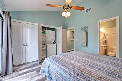 a bedroom with a bed and a ceiling fan at Steps to the Beach PCB Condo with Balcony! in Panama City Beach