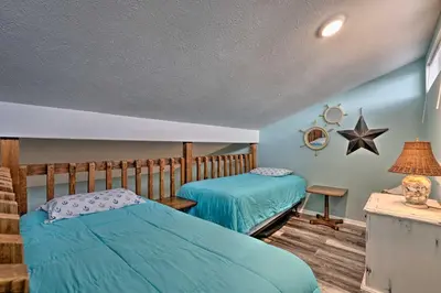 a bedroom with two beds and a star on the wall at Steps to the Beach PCB Condo with Balcony! in Panama City Beach