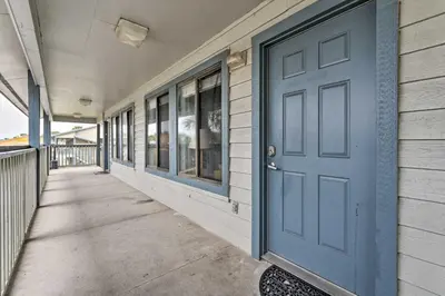 a blue door on the side of a building at Steps to the Beach PCB Condo with Balcony! in Panama City Beach