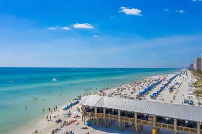 a beach with a lot of people and the ocean at Shores of Panama Beachfront 2nd Floor Unit 208! No elevators needed! in Panama City Beach