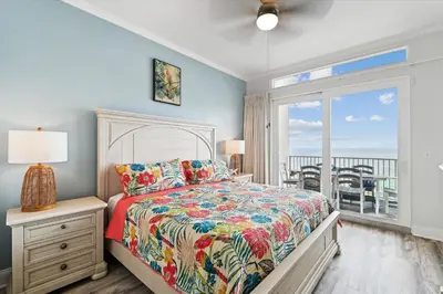 a bedroom with a bed and a view of the ocean at Laketown Wharf 2123 condo in Panama City Beach